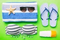 Woman swimwear and beach accessories flat lay top view on colored background Summer travel concept. bikini swimsuit Royalty Free Stock Photo
