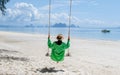 A woman on a swing on the beach in Phuket Thailand, women on a tropical beach in Thailand