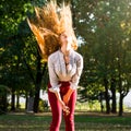 Woman swinging hair in the park, healthy hair concept