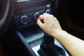 Woman switching manual transmission with the tip