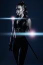 Woman, sword and assassin in studio with costume, action or cyberpunk fashion in suit. Girl, blade and leather fashion Royalty Free Stock Photo