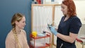 A woman with symptoms of dizziness is seen by a neurologist