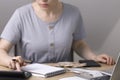 Woman at the table counting numbers on a calculator Royalty Free Stock Photo