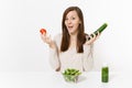 Woman at table with green detox smoothies, fresh salad in glass bowl, tomato, cucumber isolated on white background Royalty Free Stock Photo