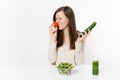 Woman at table with green detox smoothies, fresh salad in glass bowl, tomato, cucumber isolated on white background Royalty Free Stock Photo