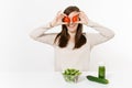 Woman at table with green detox smoothies, fresh salad in glass bowl, tomato, cucumber isolated on white background Royalty Free Stock Photo