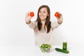 Woman at table with green detox smoothies, fresh salad in glass bowl, tomato, cucumber isolated on white background Royalty Free Stock Photo