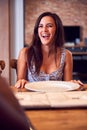 Woman At Table Waiting For Takeaway Food At Home With Friends Royalty Free Stock Photo