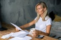 The woman at the table works with documents and bills.