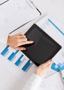 Woman with tablet pc and chart papers Royalty Free Stock Photo