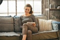 Woman with tablet pc sitting in loft apartment