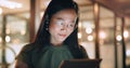 Woman, tablet and reading in night at office, focus or happy for social media app, chat or email. Asian web expert Royalty Free Stock Photo