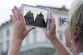 Woman with tablet taking picture to twin churches