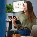 Woman, tablet and thinking in startup office with app, time management and creative project for copywriting. Girl