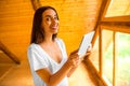 Woman with tablet in the wooden house Royalty Free Stock Photo