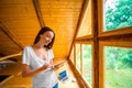 Woman with tablet in the wooden house Royalty Free Stock Photo