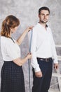 Woman tailor takes measures with male models. Fashion designer s