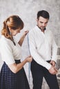 Woman tailor takes measures with male models. Fashion designer s