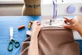 Woman tailor working on sewing machine. Hands. close up. Tailoring. Details. Royalty Free Stock Photo