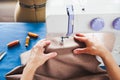 Woman tailor working on sewing machine. Hands. close up. Tailoring. Details. Close up