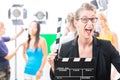 Woman with take clap at video production on film set Royalty Free Stock Photo