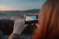 Woman take a photo of golden sunset over Palazzo Vecchio and Cathedral of Santa Maria del Fiore & x28;Duomo Royalty Free Stock Photo