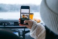 woman take picture of burger at car dashboard Royalty Free Stock Photo