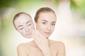 woman takes away mask with acne and pimples,green outdoor background