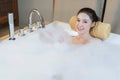Woman takes bubble bath and playing in bathtub Royalty Free Stock Photo