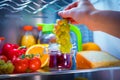 Woman takes the bunch of grapes from the open refrigerator Royalty Free Stock Photo