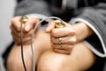 Woman takes hold of the brass handpieces of bioenergetic testing device Royalty Free Stock Photo