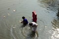 Woman takes holy dip in the Adi Ganga river near Kalighat temple