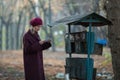 Sad woman takes a letter out of an old mailbox. Royalty Free Stock Photo