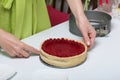 The woman takes Levington`s cake out of the mold. A cake decorated with raspberries Royalty Free Stock Photo