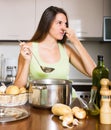 Woman takes lid off pan and feel musty smell