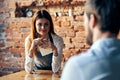 a woman takes an order from a man in a cafe serving a waiter Royalty Free Stock Photo