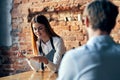 a woman takes an order from a man in a cafe serving a waiter Royalty Free Stock Photo