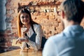 a woman takes an order from a man in a cafe serving a waiter Royalty Free Stock Photo