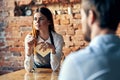 a woman takes an order from a man in a cafe serving a waiter Royalty Free Stock Photo