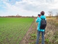 Woman takes photo of field with Cape Arkona lighthouse. Baltic Sea