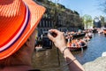 Woman takes photo of party - Koninginnedag 2012