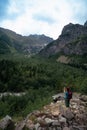 A woman takes a photo on a smartphone. the Dolra river, a hiker, walks along a stony path. travel concept. Trail to Shdugra Royalty Free Stock Photo