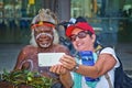 Woman takes selfie with Australian Aborigine