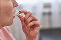 A woman takes a tablet with fish oil in capsules. Royalty Free Stock Photo