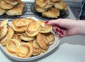 Woman takes tasty appetizing baked bun from the plate