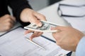 Woman taking batch of hundred dollar bills Royalty Free Stock Photo