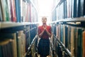 Young librarian searching books Royalty Free Stock Photo