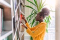 Woman taking book from library bookshelf. Young librarian searching books and taking one book from library bookshelf Royalty Free Stock Photo