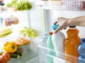 Woman taking a bottle of milk from the fridge