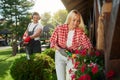 Woman taking care of flowers while man trimming bushes Royalty Free Stock Photo